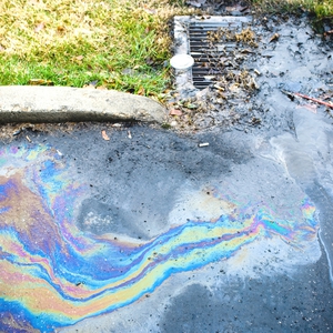 storm drain with oil running into it